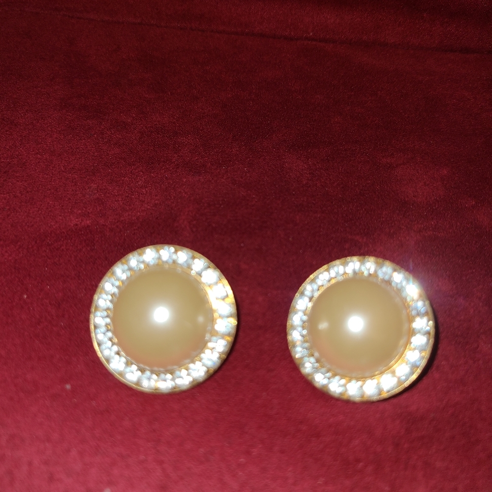 Cream color clip on ear rings surrounded with rhinestones no stones missing